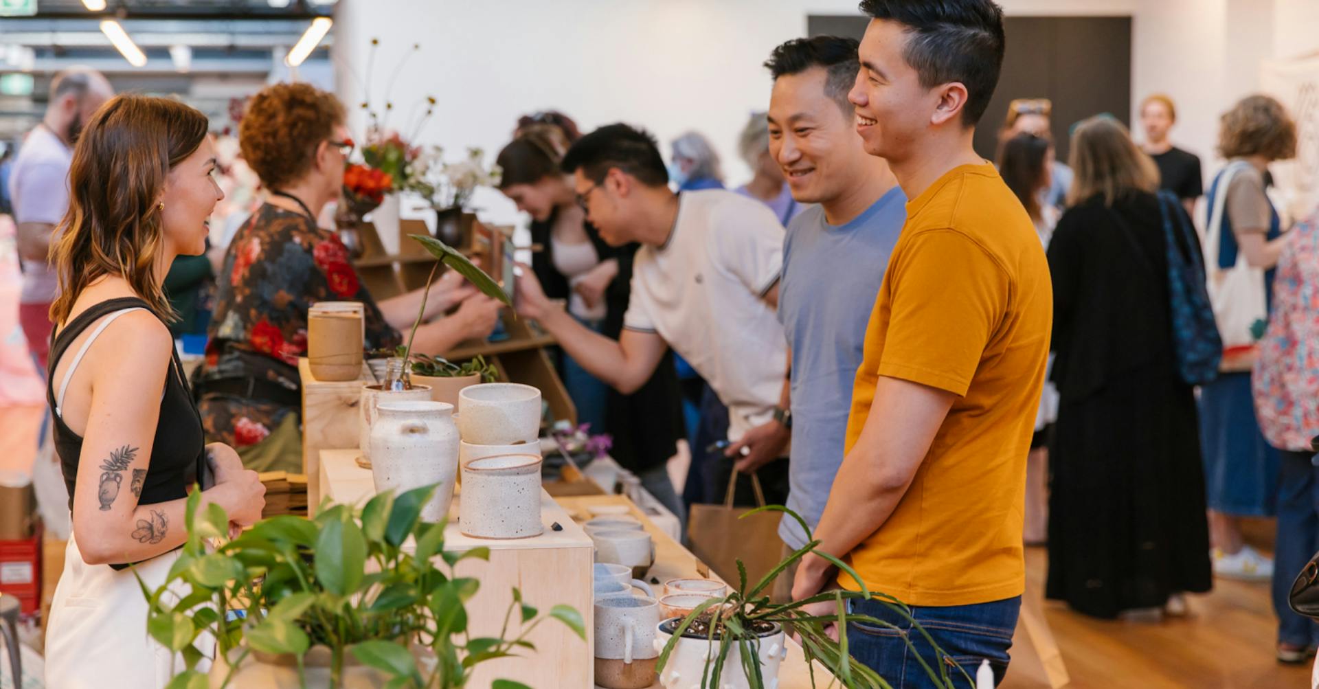 Customers interacting with a stallholder at Sydney Ceramics Market 2022.